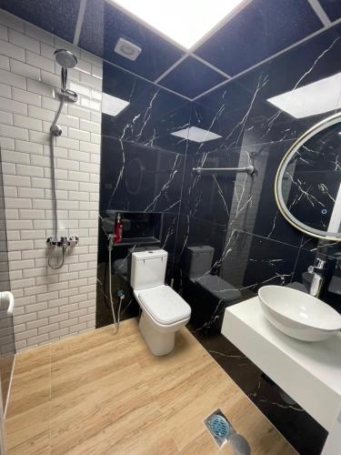 a bathroom with a toilet and a sink at Garden Villa 4, Ajman in Ajman 