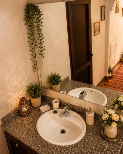 a bathroom counter with a sink and a mirror at dar leena in Essaouira