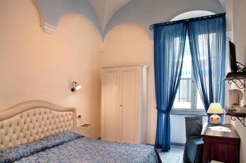 מיטה או מיטות בחדר ב-Albergo L'Antico Convitto