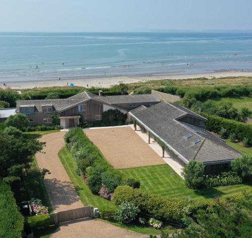 an aerial view of a house with the beach at Vegan Seafront Retreat & Yoga Studio in West Wittering in West Wittering