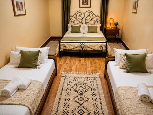 two beds in a room with two beds at dar leena in Essaouira