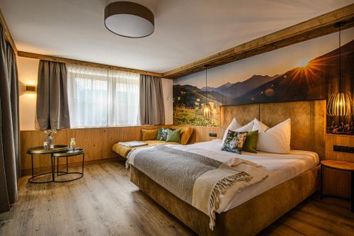 a hotel room with two beds and a painting on the wall at Zillertaler Hofchalets Schustererhof in Stumm