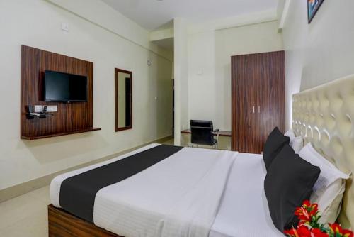 a bedroom with a large bed and a television at Triple Tree Hotels and Resorts in Bhubaneshwar
