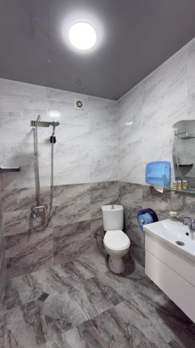 a bathroom with a toilet and a sink at Hotel Lazuri in Kvariati