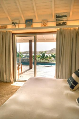a bedroom with a bed and a view of the ocean at 3 Bedroom Villa with Lagoon View Pool in Marigot
