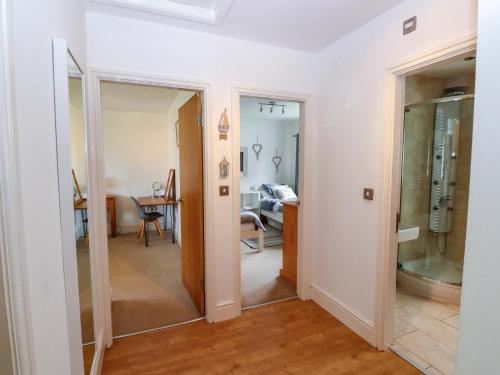a hallway with a mirror and a dining room at The Bungalow in Pwllheli