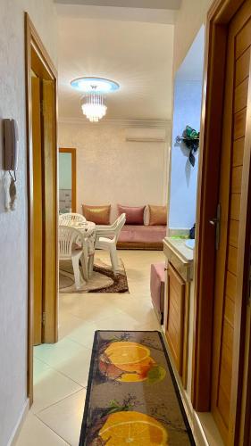a living room with a couch and a table at Martil, Avenue Oum Kalthoum in Martil