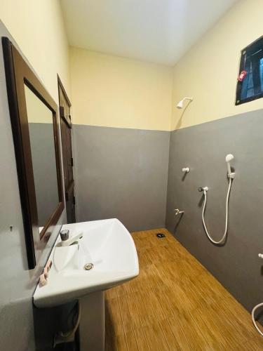 a bathroom with a sink and a shower at Ocean Bliss in Pottuvil