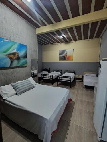 a bedroom with two beds in a room at Saqua Beach Hostel in Saquarema