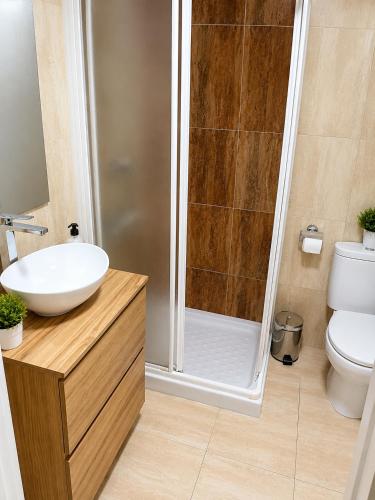 a bathroom with a shower with a sink and a toilet at Benalbeach loft in Benalmádena