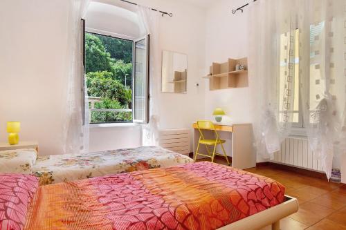 a bedroom with two beds and a window at Casa Mia in Rapallo