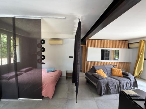 a bedroom with two beds and a mirror at PierrAnge in Grillon