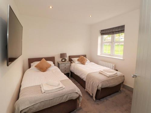 a bedroom with two beds and a window at 11 The Forge in Brampton