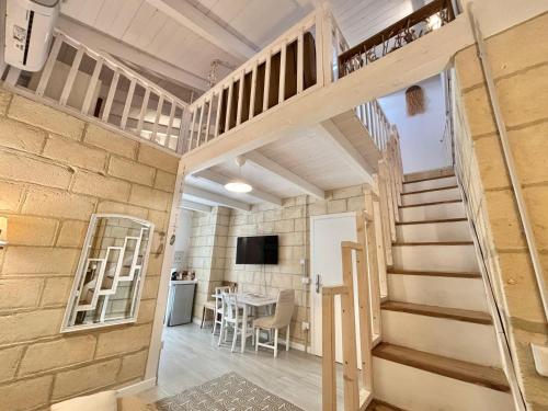 a room with a staircase and a dining room at Home Sereia in Trebisacce