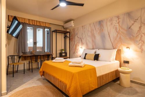 a bedroom with a large bed and a table at L anima II in Skiathos