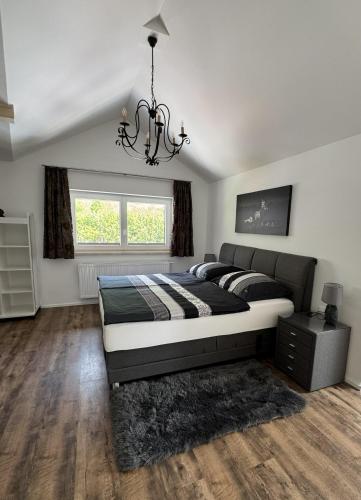 a bedroom with a bed and a chandelier at Au 10 in St. Wolfgang