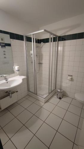 a bathroom with a shower and a sink at Ennstalerhof Hotel-Restaurant in Grossraming