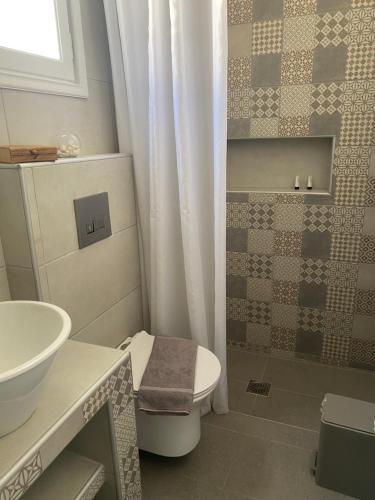 a bathroom with a toilet and a sink at Pelagos in Aegiali