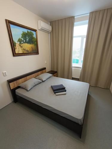 a bedroom with a large bed with two towels on it at Отель Гетьман in Broska