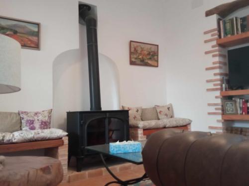 a living room with a fireplace and a couch at Can Perles casa rural in Tárbena