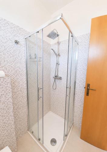 a shower with a glass door in a bathroom at Aparthotel Costa Paradiso in Lido Adriano
