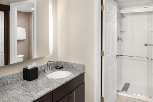 a bathroom with a sink and a shower at Residence Inn Mystic Groton in Mystic