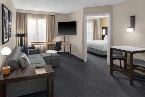 a hotel room with a couch and a bed at Residence Inn Mystic Groton in Mystic
