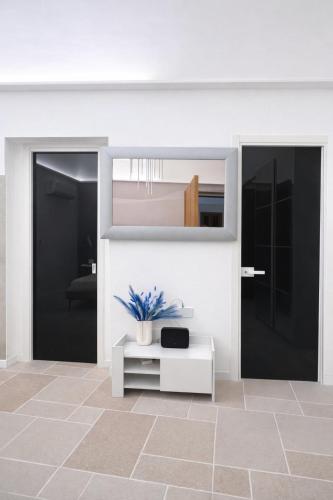 a living room with a white table and a mirror at Luxury Way Blue Essence in Molfetta