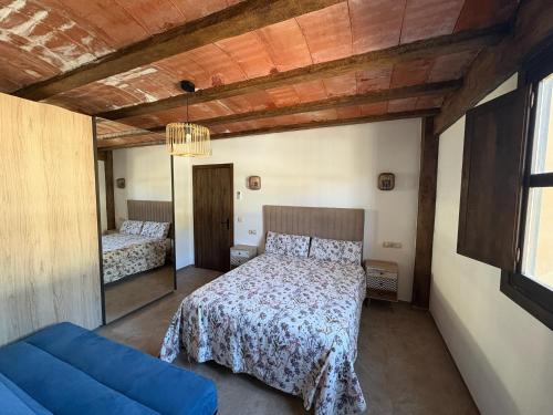 a bedroom with a bed and a blue couch at Camino Real in Jerte