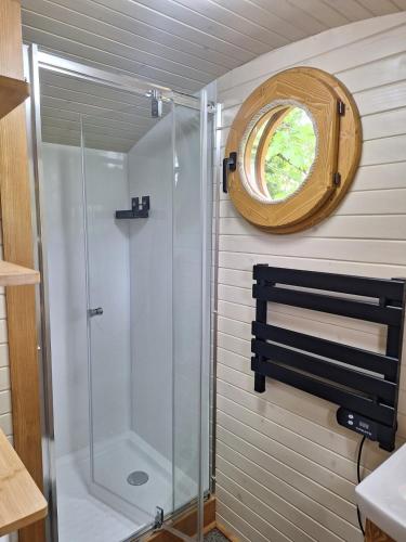a shower in a bathroom with a window at Domaine de Fondain in Laqueuille