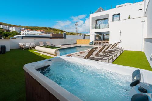 a swimming pool on the roof of a house at Paradise Villa Sea - Signature by Paradise Portugal in Ribamar