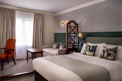 a hotel room with a bed and a couch at Kettering Park Hotel and Spa in Kettering