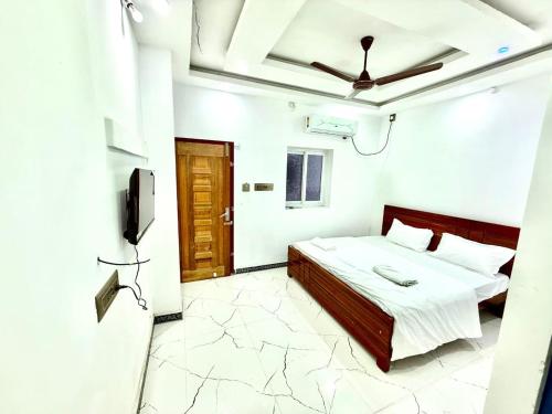 a bedroom with a bed and a television in it at natchiyar home stay in Rāmeswaram
