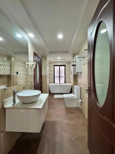 a large bathroom with a tub and a sink and a bath tub at Eldon Hotel & Apartments in Nairobi