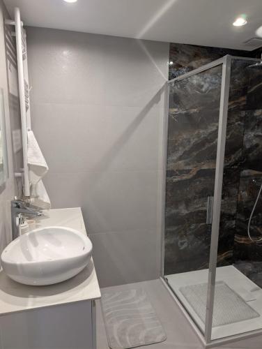 a bathroom with a sink and a shower at Apartament Las in Żagań