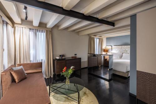 a living room with a bed and a table at Palazzo Rota Luxury Apartments in Venice