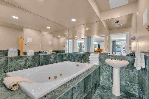 a large bathroom with a tub and a sink at Surfside Motel in Point Pleasant Beach
