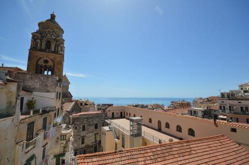 a view of a city with a clock tower at Hotel L'Antico Convitto in Amalfi