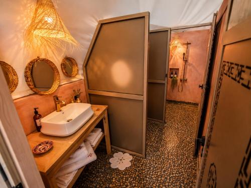 a bathroom with a sink and a shower at Luxury Sahara Desert Glamping Experience in Merzouga in Merzouga