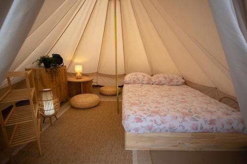 a bedroom with a bed in a tent at Maszoperia Sun4hel Kite & Wind & Surf in Jastarnia