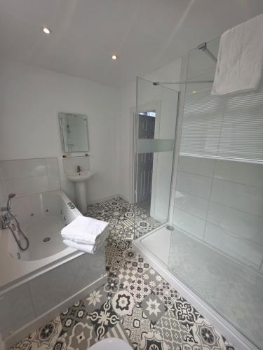 a bathroom with a shower and a tub and a toilet at Rivelyn Hotel Bar & Restaurant in Scarborough