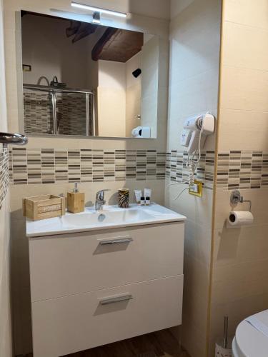 a bathroom with a white sink and a mirror at B&B Sunset Suite Belvedere in Sant'Agata de' Goti