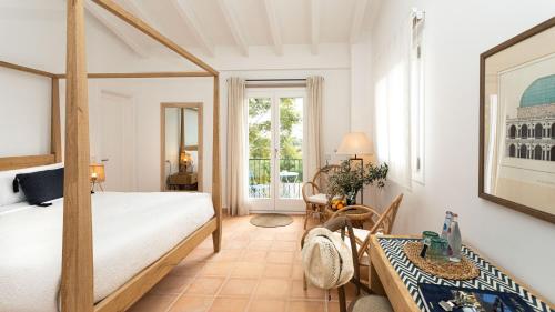 a bedroom with a large bed and a table at Finca Son Miranda in Sencelles