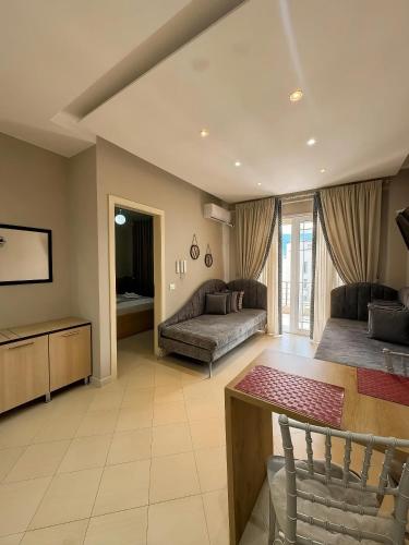 a living room with a couch and a table at Solis Apartments in Vlorë