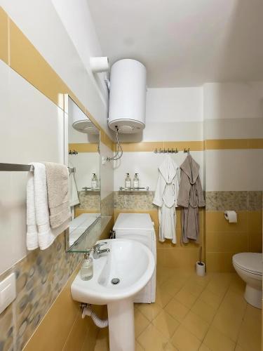 a bathroom with a sink and a toilet at Solis Apartments in Vlorë