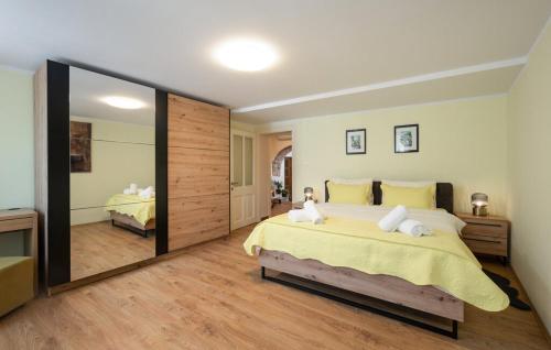 a bedroom with a large bed and a large mirror at Apartment Avelina in Mošćenice