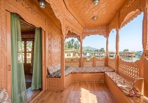 an ornate bedroom with a bed on a gondola at The Martin's Houseboat in Srinagar
