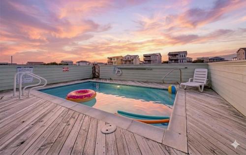 a swimming pool on the roof of a house at Pelican Watch - Kitty Hawk MP 3, 16 Yards to Beach, Ocean View, Pool, Hot Tub, Pool Table, Flex Stays in Kitty Hawk