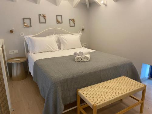 a bedroom with a bed with two towels on it at Fedon in Halki