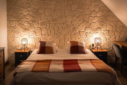 a bedroom with a bed with two lamps on either side at Domaine de Bersaillin in Bersaillin